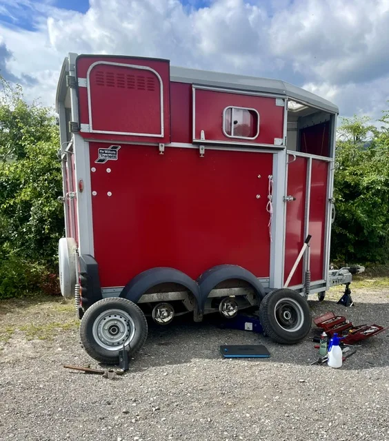 Ifor Williams horsebox jacked up on site with both wheels off for a brake service